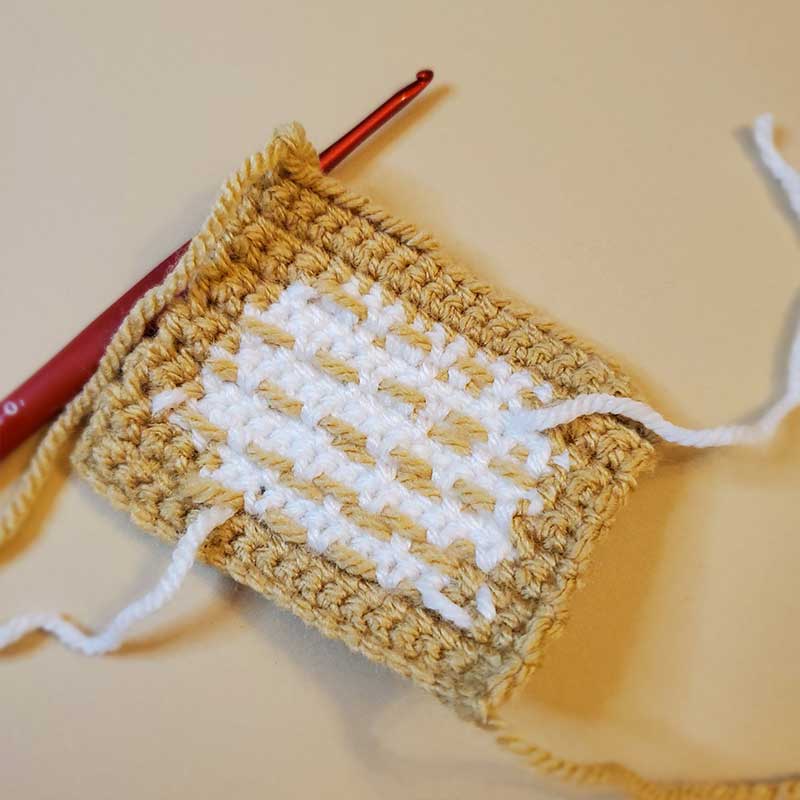 back of crochet beignet showing colorwork