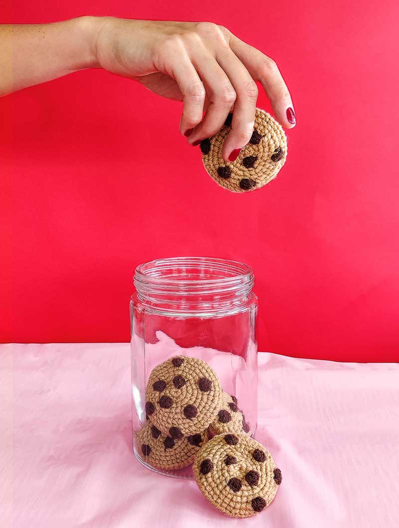 hand pulling crochet cookie from jar