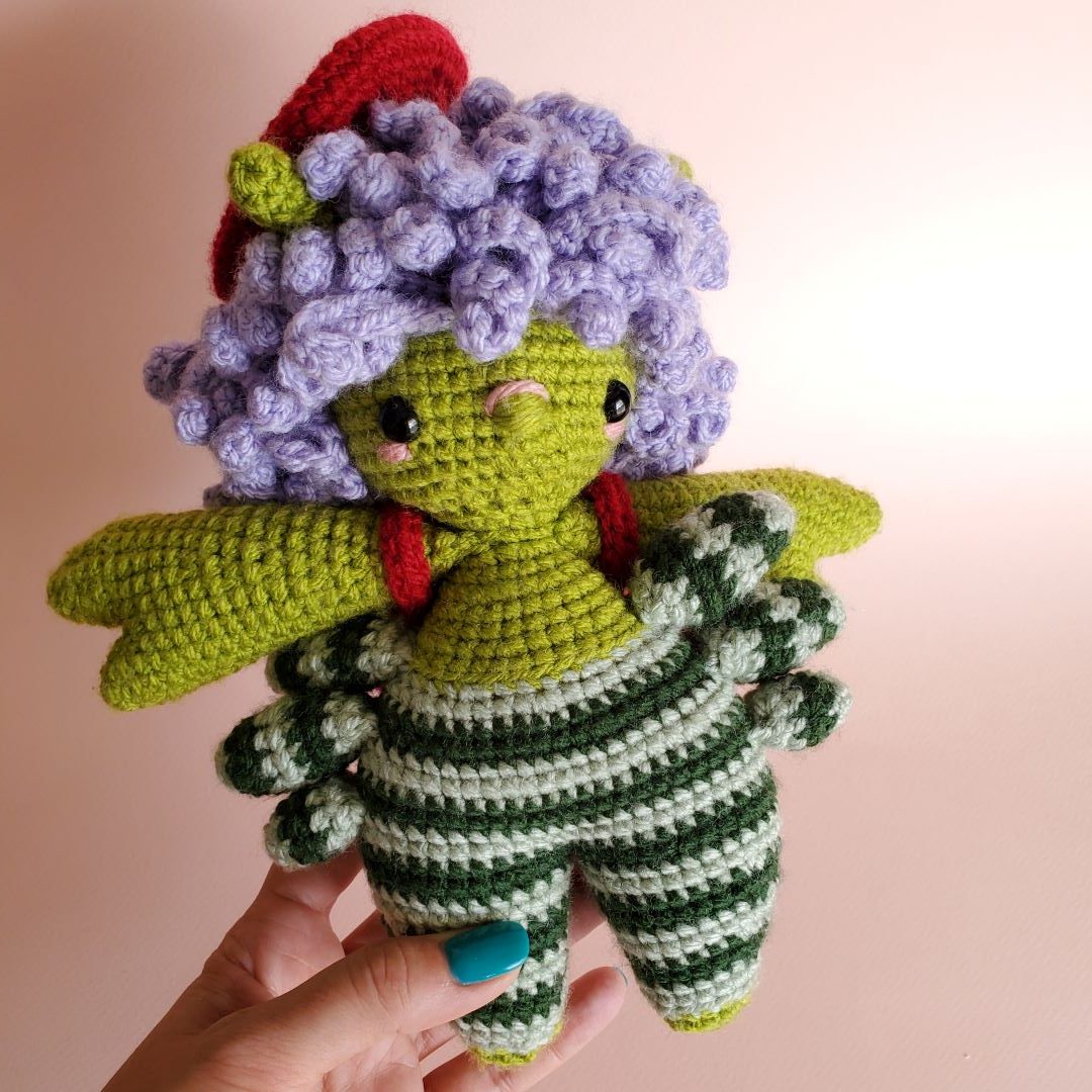 Green crocheted crab person