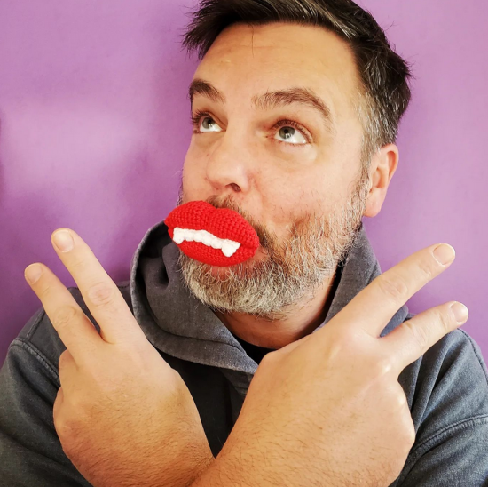 man wearing crocheted wax lips